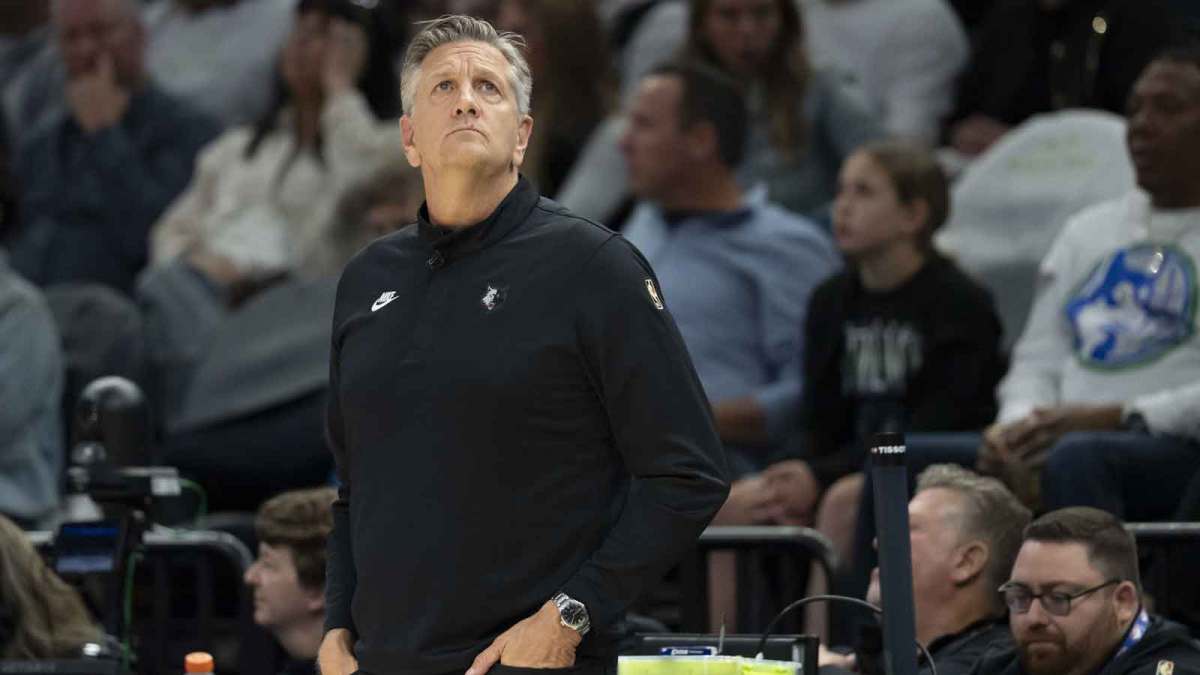 Timberwolves head coach Chris Finch looks on against the Los Angeles Lakers in the first half at Target Center with Lakers' JJ Redick in the background