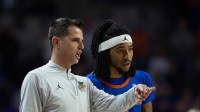 Florida head coach Todd Golden talks with Florida guard Boogie Fland (0) during the second half of an NCAA mens basketball against Florida State game at Exactec Areana at the Steven C. O Connell Center in Gainesville, FL on Tuesday, November 11, 2025. Florida beat FSU 78-76