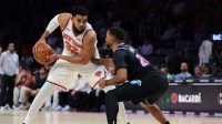 New York Knicks center Karl-Anthony Towns (32) protects the basketball from Miami Heat guard Norman Powell (24) during the third quarter at Kaseya Center.
