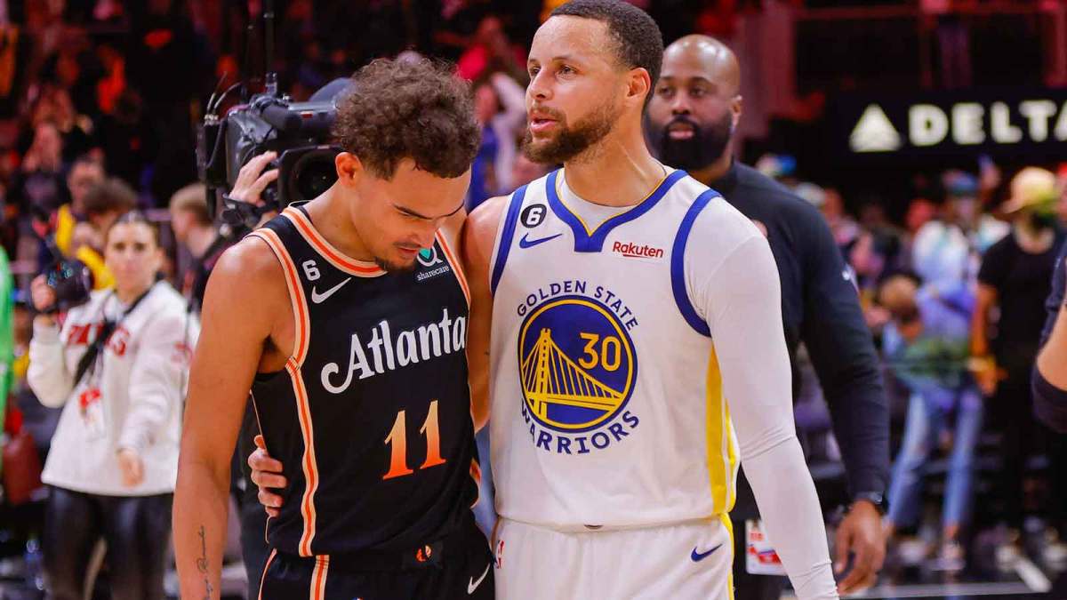 Atlanta Hawks guard Trae Young (11) talks to Golden State Warriors guard Stephen Curry (30) after a game at State Farm Arena.