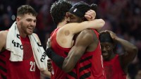 Blazers forward Jerami Grant (9), right, celebrates with forward Deni Avdija (8) after a game against the Denver Nuggets at Moda Center. Grant scored the game winning free throws with Warriors' Draymond Green in the background