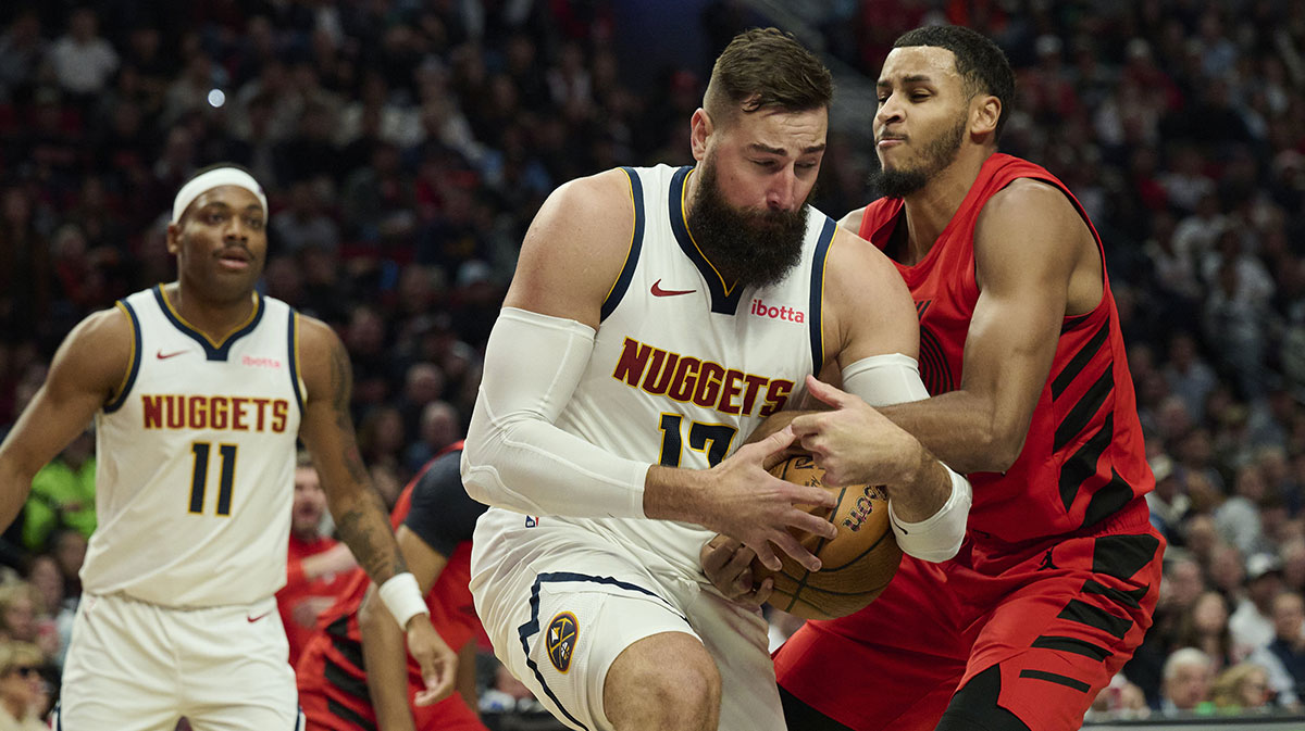 Trail Blazers forward Kris Murray (24) ties up Denver Nuggets center Jonas Valanciunas (17) during the second half at Moda Center