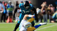 Jacksonville Jaguars defensive end Travon Walker (44) hurries Los Angeles Chargers quarterback Justin Herbert (10) as he is called for intentional grounding during the first quarter of an NFL football game at EverBank Stadium.