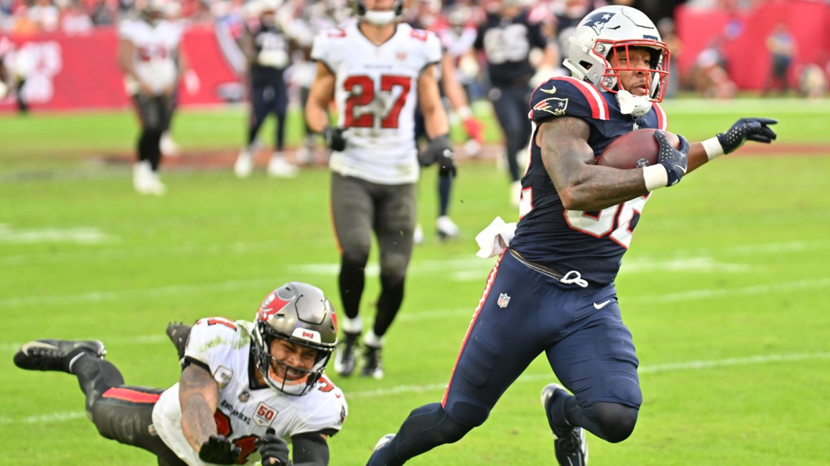 New England Patriots running back Treveyon Henderson (32) runs for a touchdown past Tampa Bay Buccaneers cornerback Josh Hayes (32) during the third quarter at Raymond James Stadium.