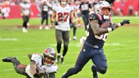 New England Patriots running back Treveyon Henderson (32) runs for a touchdown past Tampa Bay Buccaneers cornerback Josh Hayes (32) during the third quarter at Raymond James Stadium.