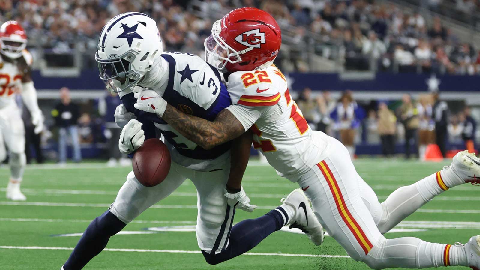 Kansas City Chiefs cornerback Trent McDuffie (22) forces a fumble from Dallas Cowboys wide receiver George Pickens (3) during the fourth quarter at AT&T Stadium.