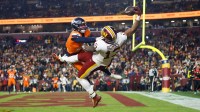 Nov 30, 2025; Landover, Maryland, USA; Washington Commanders wide receiver Treylon Burks (13) makes a catch for a touchdown defended by Denver Broncos cornerback Riley Moss (21) in the third quarter of the game at Northwest Stadium. Mandatory Credit: Peter Casey-Imagn Images