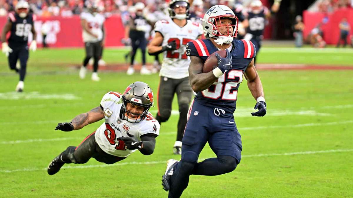 New England Patriots running back Treveyon Henderson (32) runs for a touchdown past Tampa Bay Buccaneers cornerback Josh Hayes (32) during the third quarter at Raymond James Stadium.