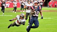 New England Patriots running back Treveyon Henderson (32) runs for a touchdown past Tampa Bay Buccaneers cornerback Josh Hayes (32) during the third quarter at Raymond James Stadium.