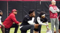 Arizona Cardinals quarterbacks Jacoby Brissett and Kyler Murray take a knee after linebacker J.J. Russell (51) suffered a head and neck injury during training camp at State Farm Stadium in Glendale on July 24, 2025.