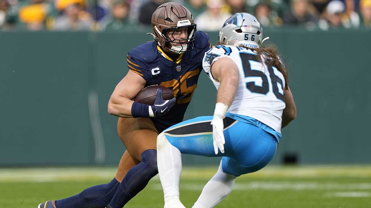 Green Bay Packers tight end Tucker Kraft (85) runs after a catch against Carolina Panthers linebacker Christian Rozeboom (56) during the first half at Lambeau Field.