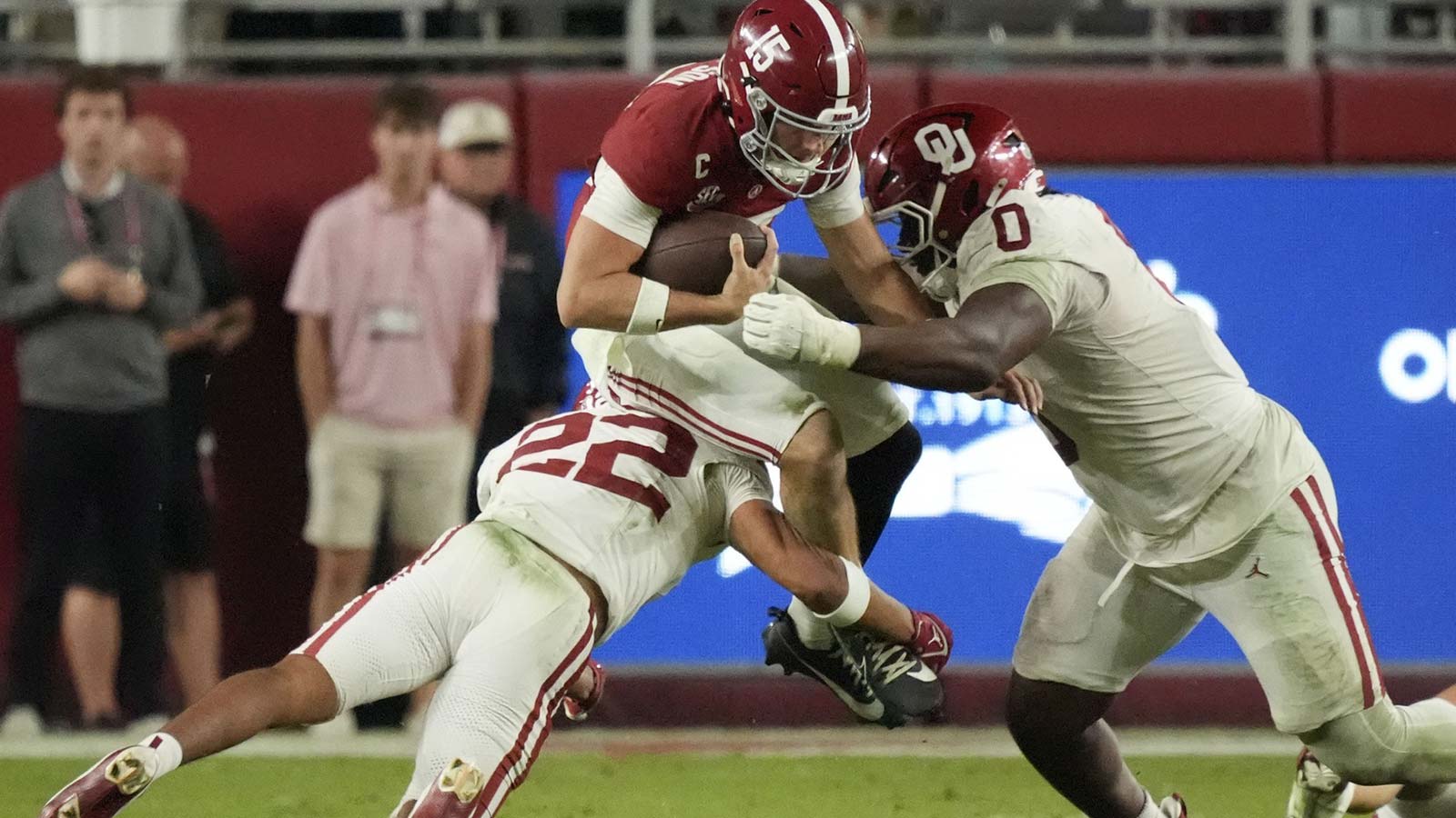 Oklahoma Sooners defensive back Peyton Bowen (22) and defensive lineman David Stone (0) combine to tackle Alabama Crimson Tide quarterback Ty Simpson (15) at Saban Field at Bryant-Denny Stadium. Oklahoma defeated Alabama 23-21.