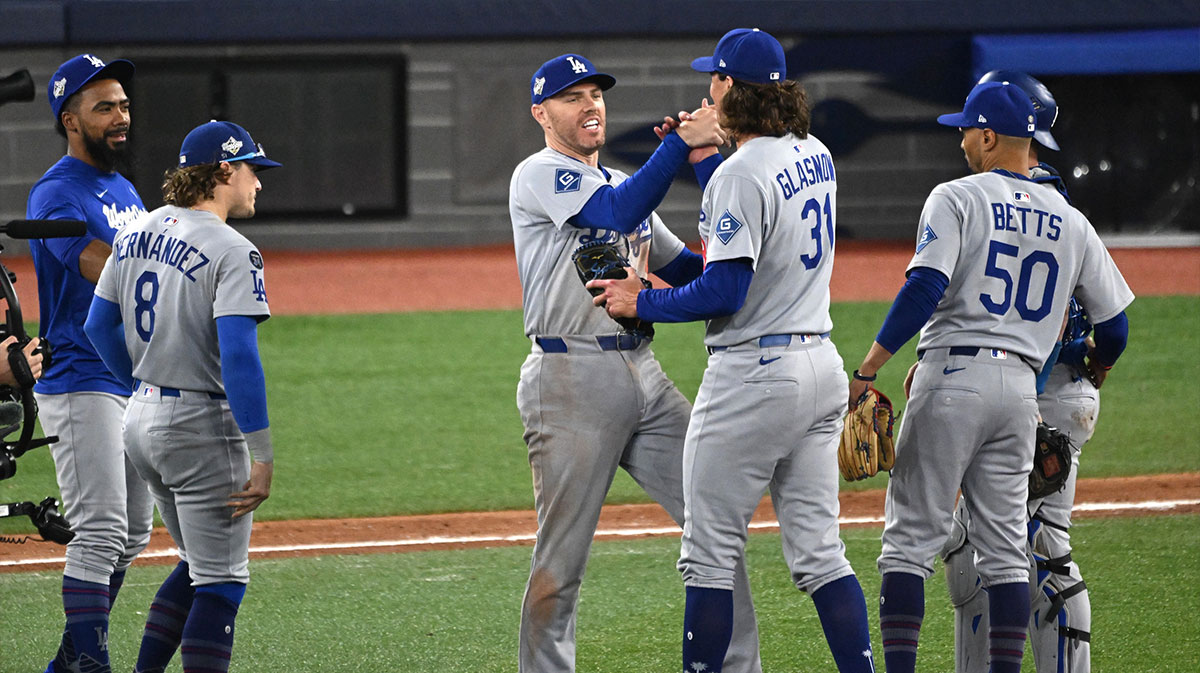 Los Angeles Dodgers first baseman Freddie Freeman (5) and pitcher Tyler Glasnow (31) celebrate after defeating the Toronto Blue Jays in game six of the 2025 MLB World Series at Rogers Centre. 