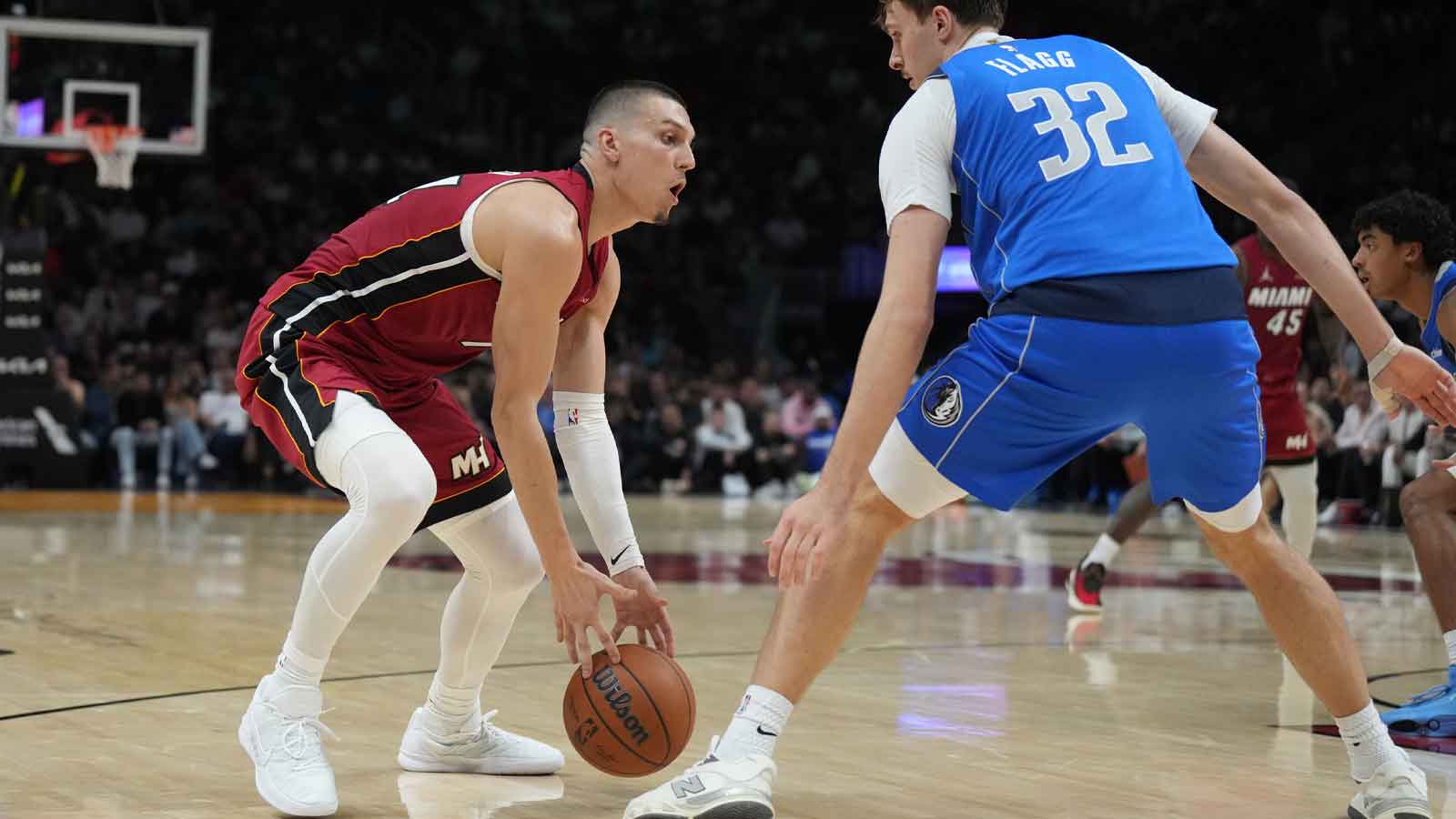 Dallas Mavericks forward Cooper Flagg (32) defends Miami Heat guard Tyler Herro (14) during the first half at Kaseya Center. 