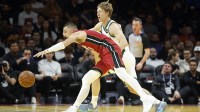 Miami Heat guard Tyler Herro (14) and Milwaukee Bucks guard AJ Green (20) fight for a loose ball during the first half of an NBA Cup game at Kaseya Center.