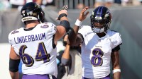 Baltimore Ravens quarterback Lamar Jackson (8) and center Tyler Linderbaum (64) warm up before the game against the Cincinnati Bengals at Paycor Stadium.