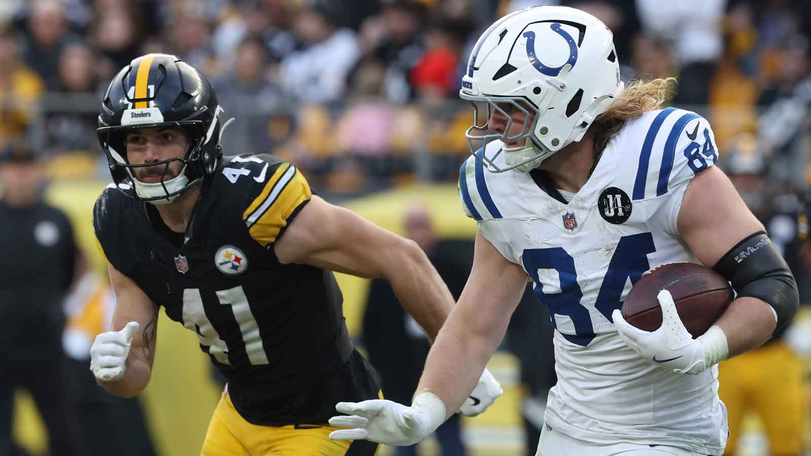 Indianapolis Colts tight end Tyler Warren (84) runs after a catch as Pittsburgh Steelers linebacker Payton Wilson (41) chases during the fourth quarter at Acrisure Stadium.