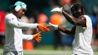 Miami Dolphins wide receiver Jaylen Waddle (L) and wide receiver Tyreek Hill (R) celebrate while warming up for the game against the New England Patriots during the first half at Hard Rock Stadium.