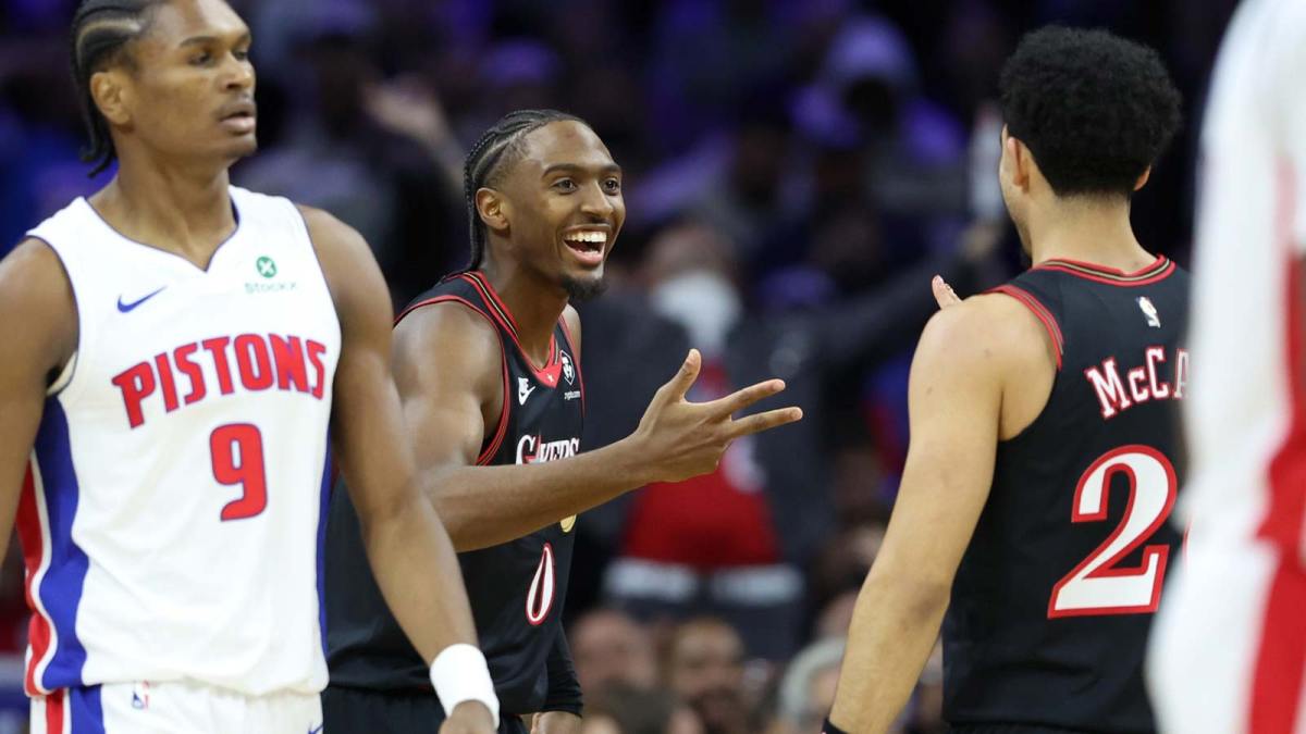 Philadelphia 76ers guard Tyrese Maxey (0) reacts guard Jared McCain (20) in front of Detroit Pistons guard Ausar Thompson (9) after his three pointer during the second quarter at Xfinity Mobile Arena.