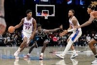 Philadelphia 76ers guard VJ Edgecombe (77) sets the play while defended by Brooklyn Nets guard Drake Powell (4) during the first half at Barclays Center.