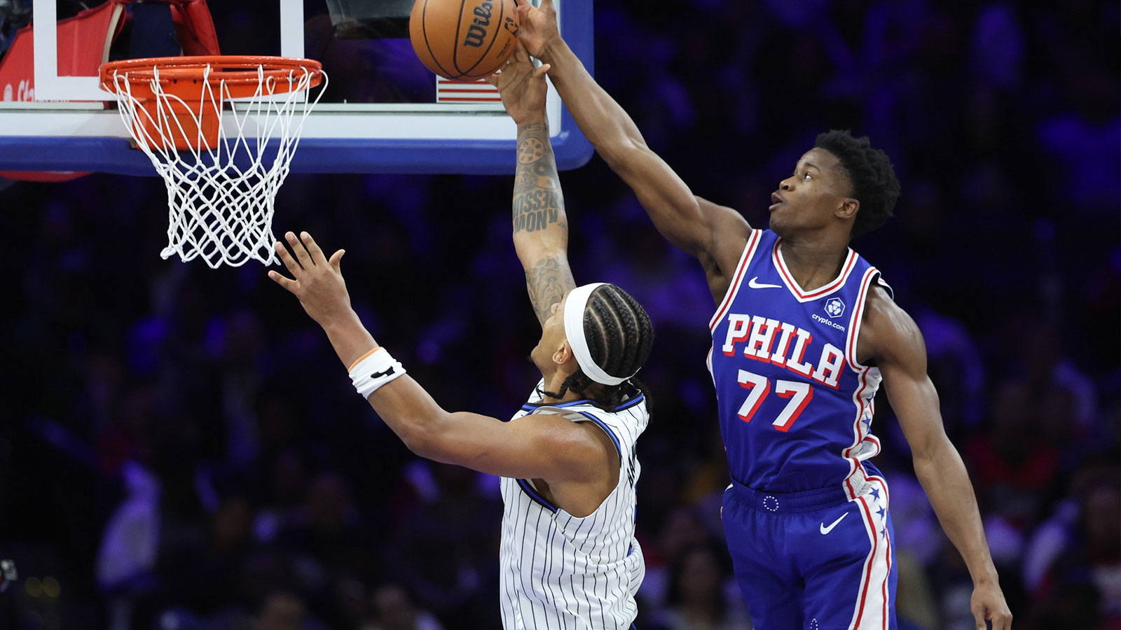 Philadelphia 76ers guard VJ Edgecombe (77) blocks the shot of Orlando Magic forward Paolo Banchero (5) during the third quarter at Xfinity Mobile Arena.