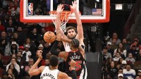 Chicago Bulls forward Isaac Okoro (35) shoots between San Antonio Spurs forward Victor Wembanyama (1) and Spurs center Luke Kornet (7) during the second half at the United Center.