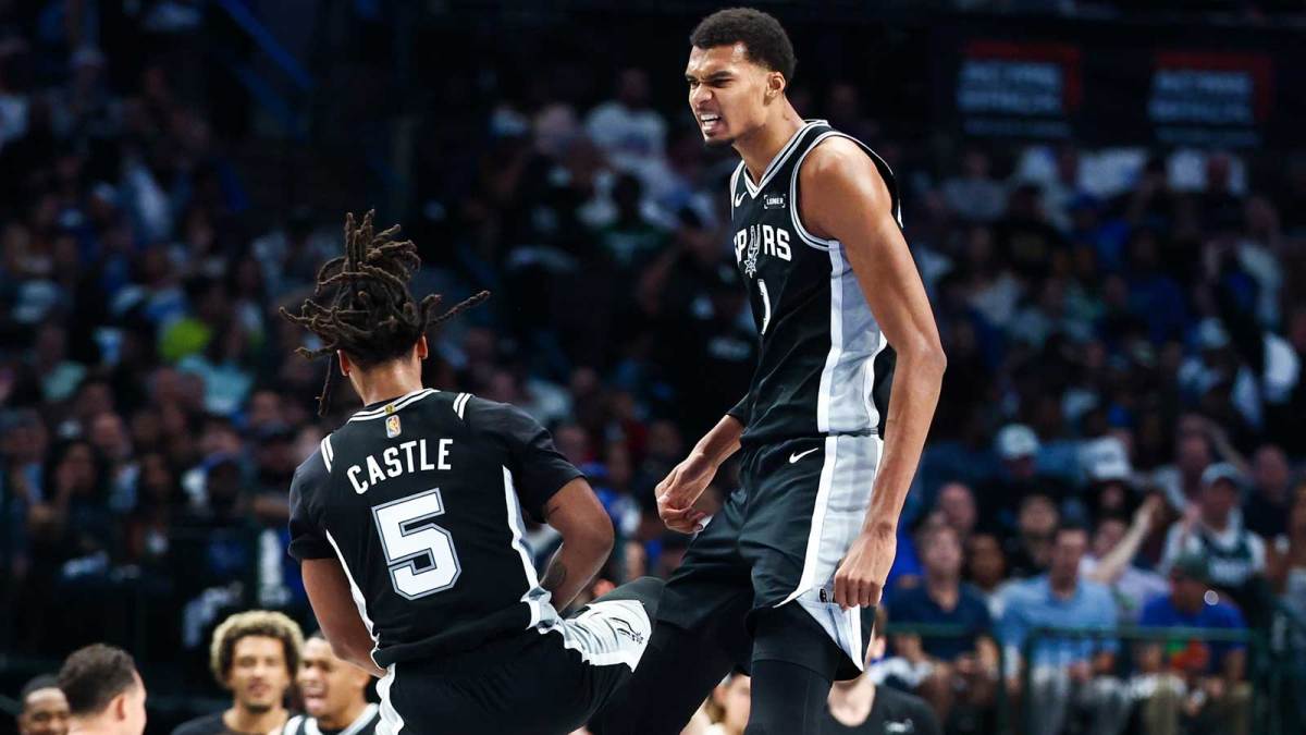 San Antonio Spurs forward Victor Wembanyama (1) celebrates with San Antonio Spurs guard Stephon Castle (5) during the first half against the Dallas Mavericks at American Airlines Center.
