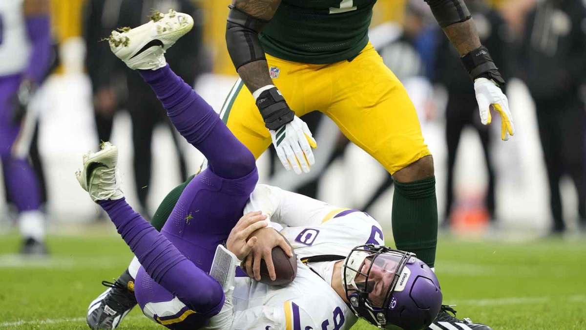 Minnesota Vikings quarterback Max Brosmer (12) lays on the turf after being sacked by. Green Bay Packers defensive end Micah Parsons (1) during the second half at Lambeau Field