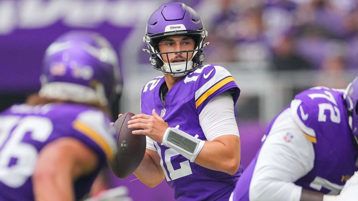 Minnesota Vikings quarterback Max Brosmer (12) drops back to pass against the New England Patriots in the third quarter at U.S. Bank Stadium.