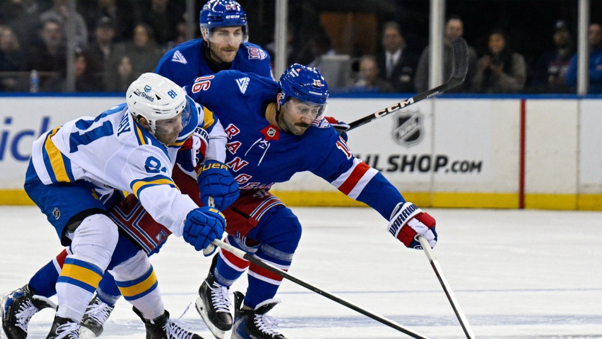 New York Rangers center Vincent Trocheck (16) and St. Louis Blues left wing Dylan Holloway (81) battle for the puck during the second period at Madison Square Garden.