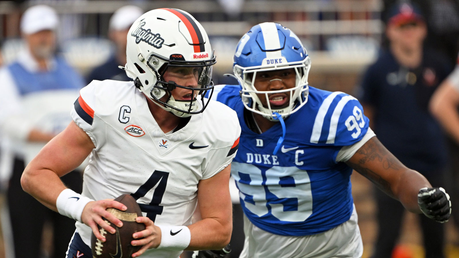 Virginia Cavaliers quarter back Chandler Morris (4) looks for an opening against Duke Blue Devils defensive tackle Aaron Hall (99) during the first quarter at Wallace Wade Stadium.