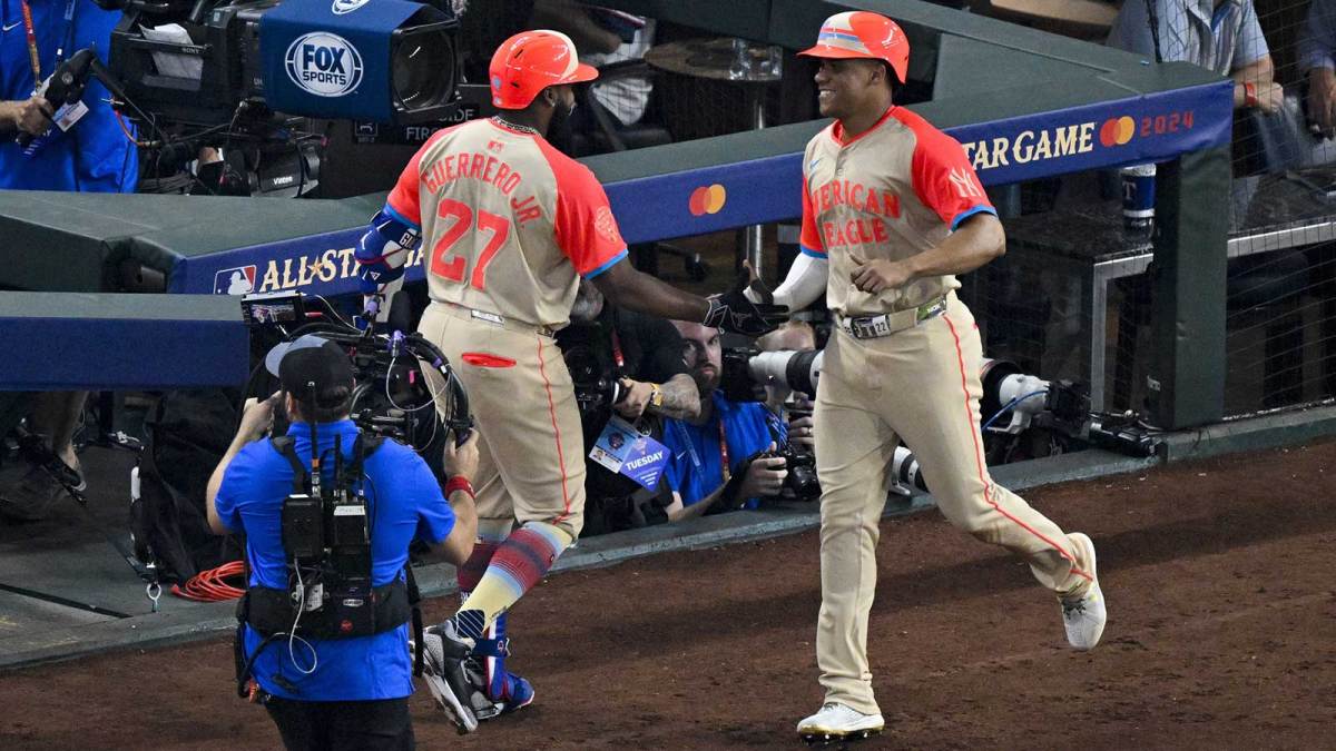 American League first baseman Vladimir Guerrero Jr. of the Toronto Blue Jays (27) and American League outfielder Juan Soto of the New York Yankees (22) celebrate after Soto scores against the National League during the third inning of the 2024 MLB All-Star game at Globe Life Field.