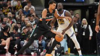 San Antonio Spurs forward Victor Wembanyama (1) dribbles against Golden State Warriors forward Draymond Green (23) in the second half at Frost Bank Center.