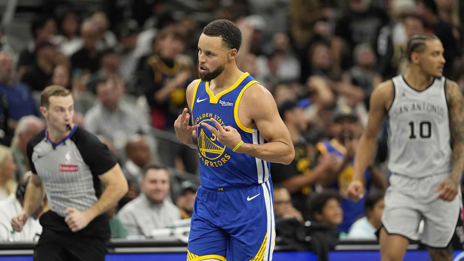 Warriors guard Stephen Curry (30) reacts after scoring a three-point basket during the second half against the San Antonio Spurs at Frost Bank Center