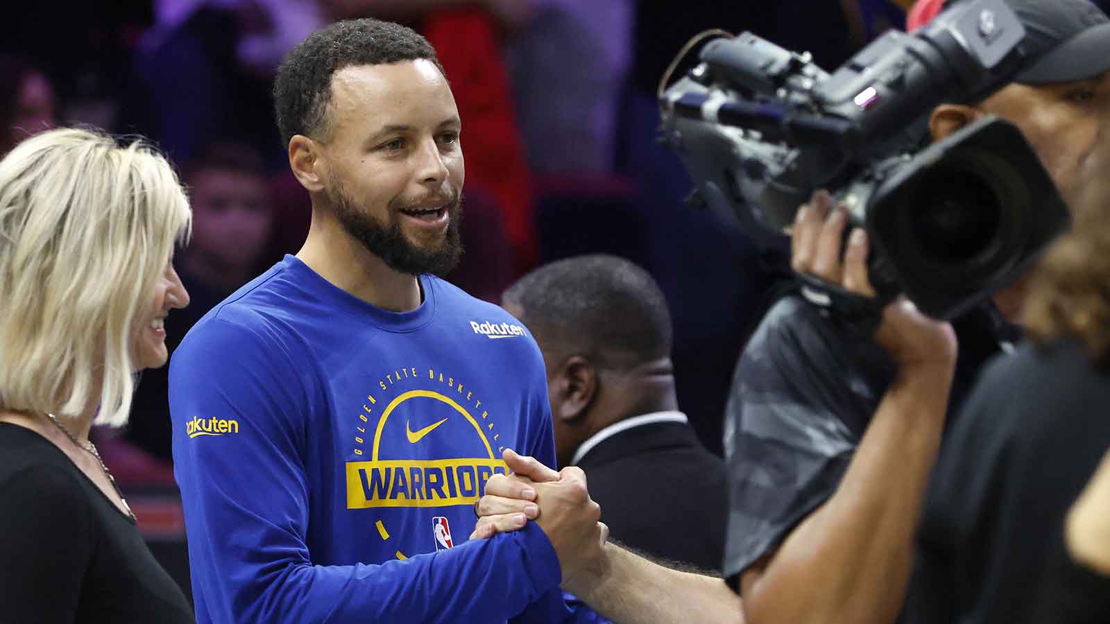Warriors guard Stephen Curry (30) greets fans before the game against the Miami Heat at Kaseya Center