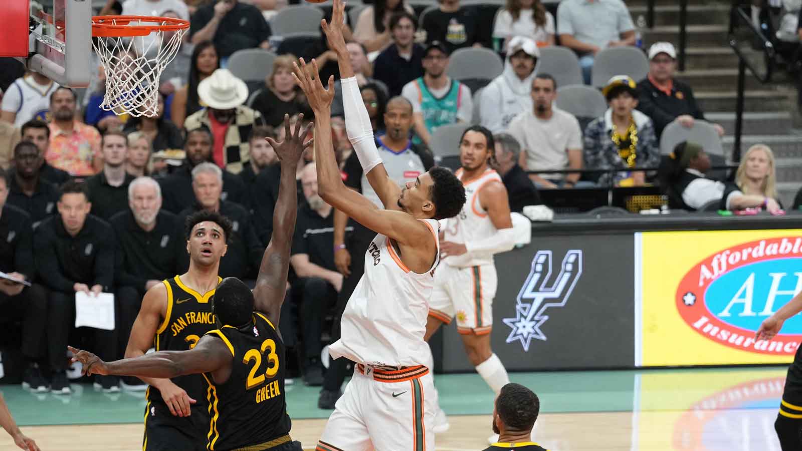 Spurs center Victor Wembanyama (1) shoots over Golden State Warriors forward Draymond Green (23) in the second half at Frost Bank Center