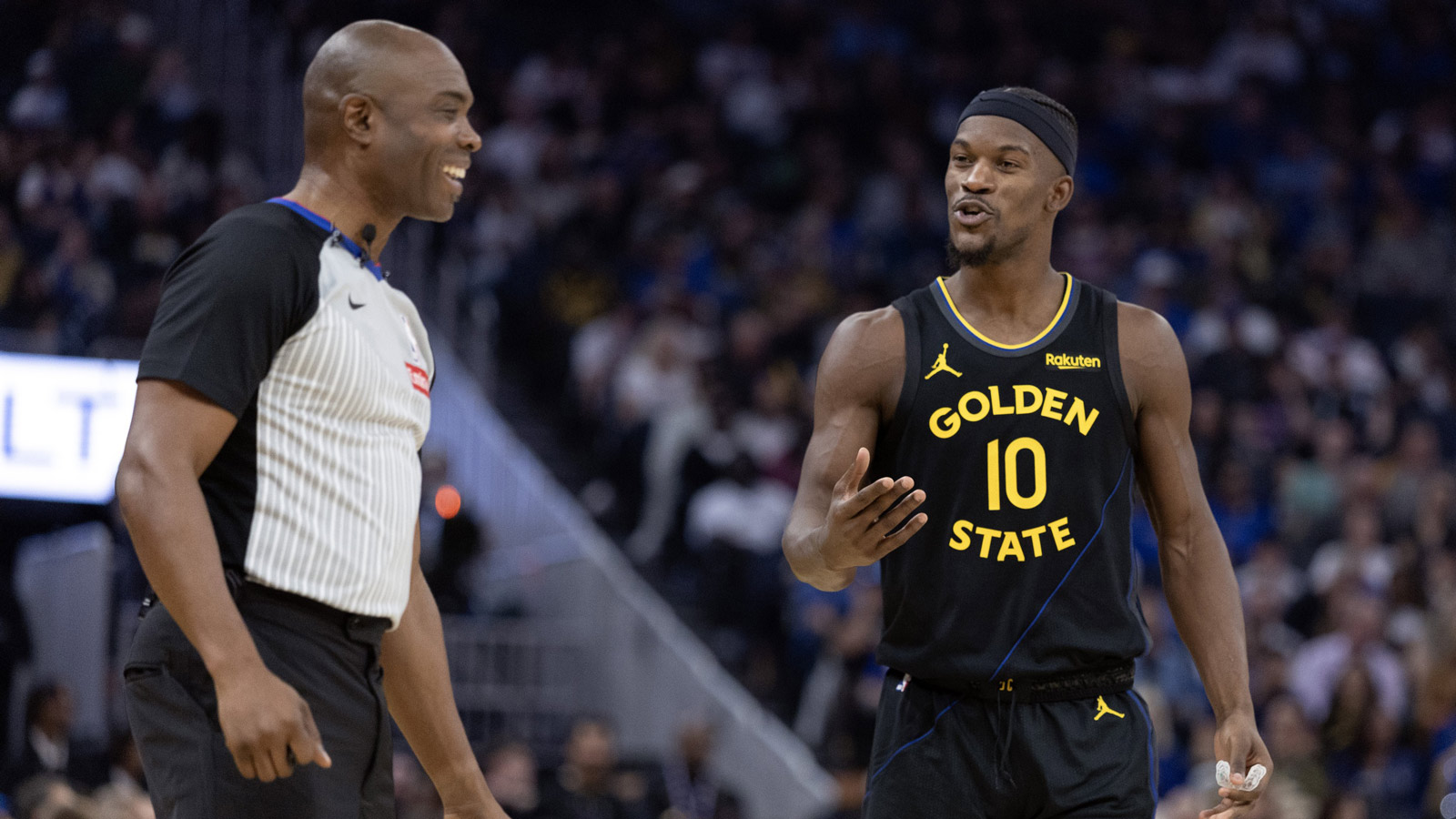 Warriors forward Jimmy Butler III (10) shares a laugh with referee Courtney Kirkland during the second quarter at Chase Center