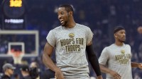 Warriors forward Jonathan Kuminga (1) warms up before facing the Indiana Pacers at Chase Center with the Pelicans logo in the background