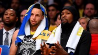 Golden State Warriors guard Stephen Curry (30) and forward Kevin Durant (35) sit on the bench in the second half of the game against the Los Angeles Lakers at Staples Center.
