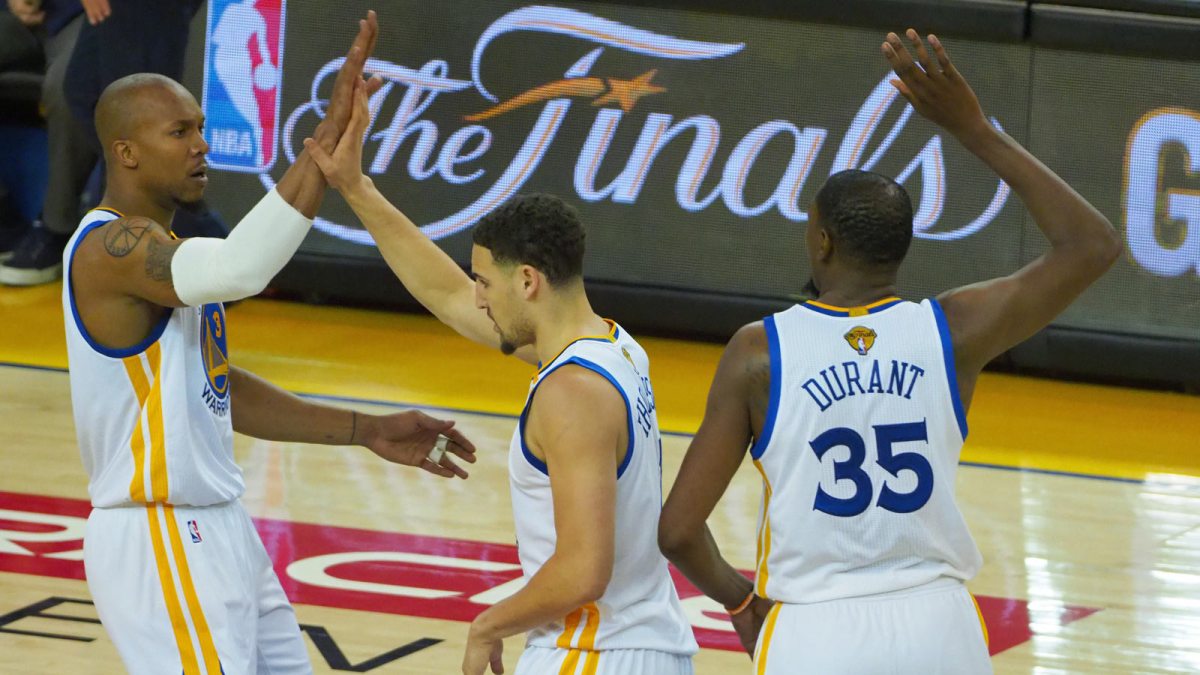Golden State Warriors guard Klay Thompson (11) celebrates with teammates David West (3) and Kevin Durant (35) against the Cleveland Cavaliers during the first half in game two of the 2017 NBA Finals at Oracle Arena.