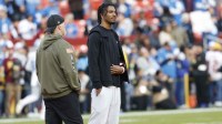 Washington Commanders head coach Dan Quinn stands with quarterback Jayden Daniels (5) on the sidelines during warmups prior to a game against the Detroit Lions at Northwest Stadium.