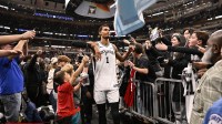 San Antonio Spurs forward Victor Wembanyama (1) greets fans after the second half against the Chicago Bulls at the United Center.