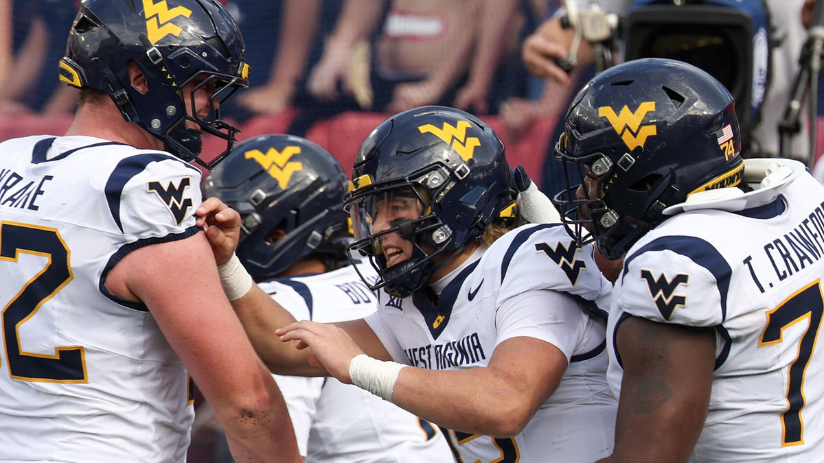West Virginia Mountaineers quarterback Scotty Fox Jr. (15) celebrates his touchdown with teammates against the Houston Cougars in the second half at TDECU Stadium.