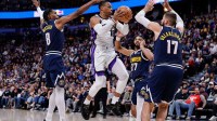 Sacramento Kings guard Russell Westbrook (18) controls the ball under pressure from Denver Nuggets guard Peyton Watson (8) and guard Jamal Murray (27) and center Jonas Valanciunas (17) in the third quarter at Ball Arena.