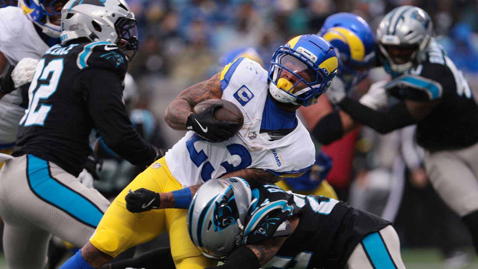 Los Angeles Rams running back Kyren Williams (23) rushes and is tackled by Carolina Panthers safety Lathan Ransom (22) during the second quarter at Bank of America Stadium.