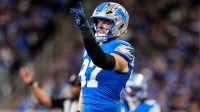 Detroit Lions defensive end Aidan Hutchinson (97) signals teammates as he runs onto the field for a play against Minnesota Vikings during the first half at Ford Field.