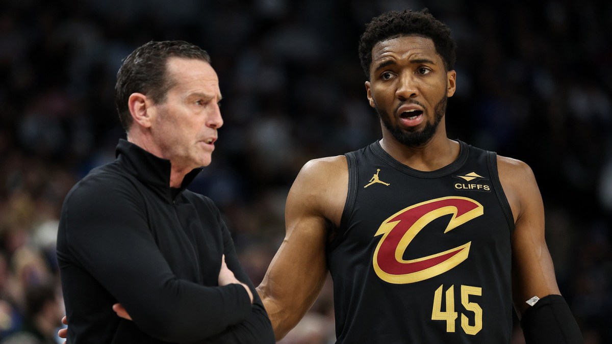 Cleveland Cavaliers guard Donovan Mitchell (45) talks with head coach Kenny Atkinson during the second quarter against the Minnesota Timberwolves at Target Center.