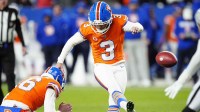 Denver Broncos kicker Wil Lutz (3) kicks the game winning field goal as punter Jeremy Crawshaw (16) assists in the fourth quarter against the Kansas City Chiefs at Empower Field at Mile High.