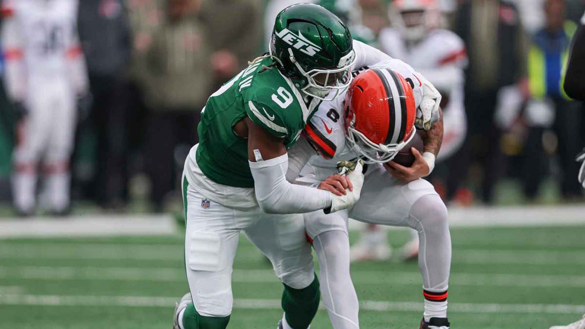 New York Jets safety Andre Cisco (8) is sacked by New York Jets defensive end Will McDonald IV (9) during the first half at MetLife Stadium.