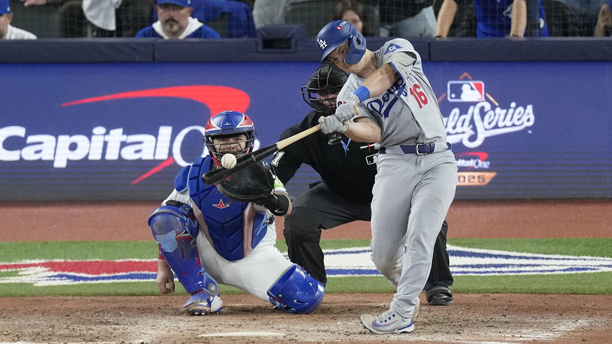 Los Angeles Dodgers catcher Will Smith (16) hits a home run against the Toronto Blue Jays in the eleventh inning during game seven of the 2025 MLB World Series at Rogers Centre.